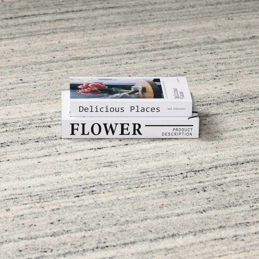 Close-up of the hand-tufted Capote Charcoal Area Rug showing charcoal, ivory, and slate gray tones. Styleshot