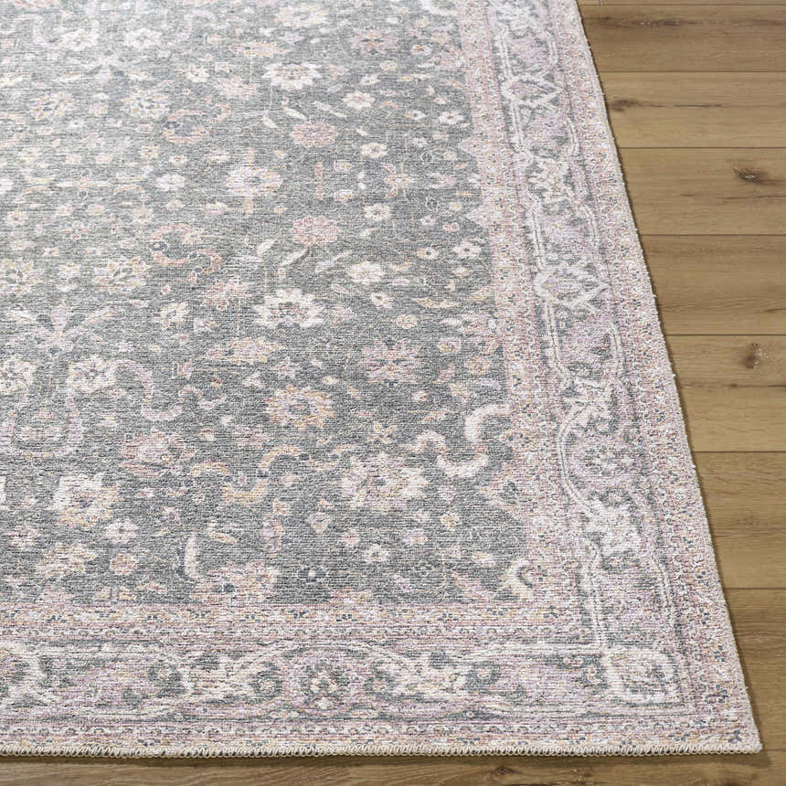 Close up of the Anando Washable Area Rug. Machine woven rug with a traditional floral pattern in cream, green, and pale pink. Front