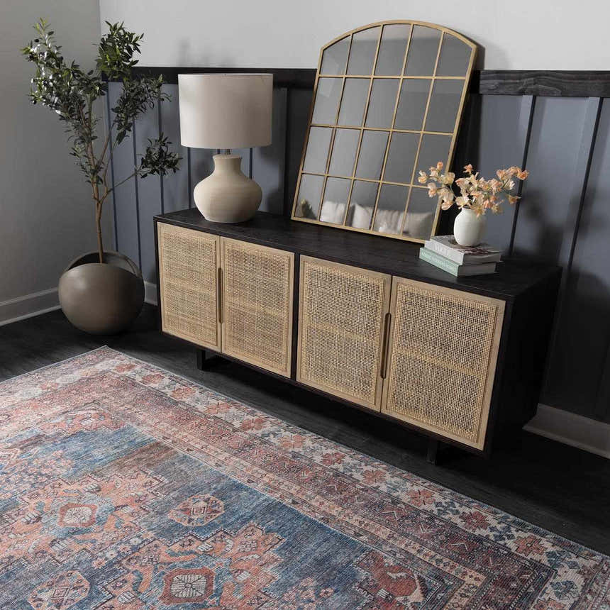 Entryway scene with Baltinglass Rust & Blue Washable Area Rug, dark console table, lamp, and gold mirror. Roomscene-Rectangle