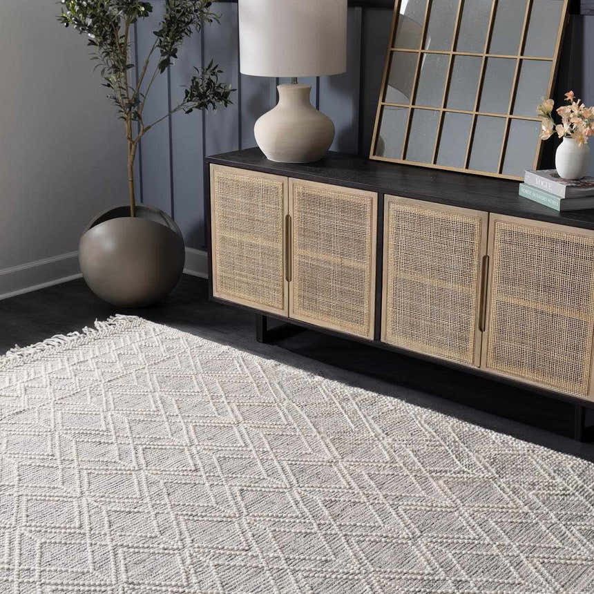 Living room scene with ivory Ramsbury Wool Area Rug, geometric pattern, under a console table with lamp and decor. Roomscene-Rectangle