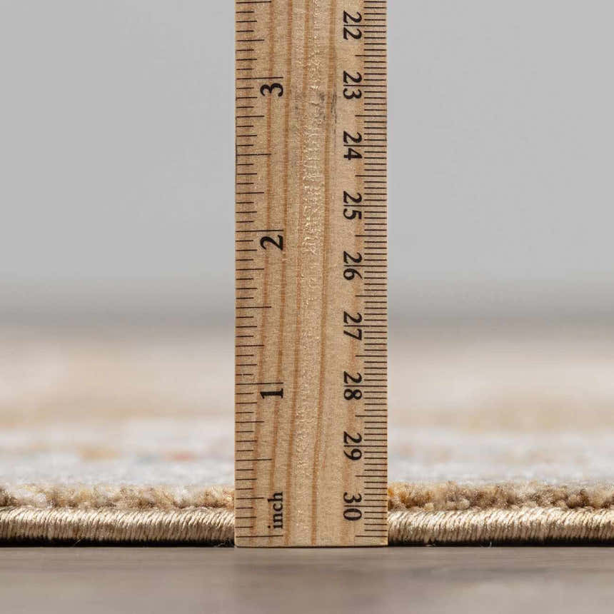 Close-up of the thick pile of the Rangeville Luxe Statement Rug, showing its plush texture and height with a ruler. Pile