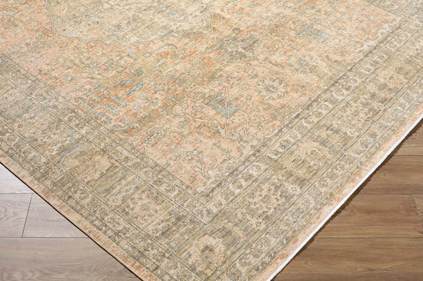 Close-up of Becki Owens x Livabliss Renaissance BORI-2301 rug. Beige, denim, coral, and tan traditional pattern. Corner