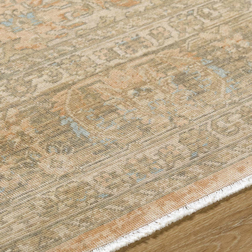 Close-up of the hand-crafted Becki Owens x Livabliss Renaissance BORI-2301 rug. Beige, denim, coral, and tan traditional pattern. Texture