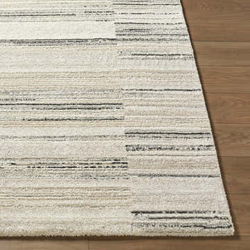 Close up of the Rumer Luxe Rug showing a beige, cream, and black contemporary stripe pattern. Front