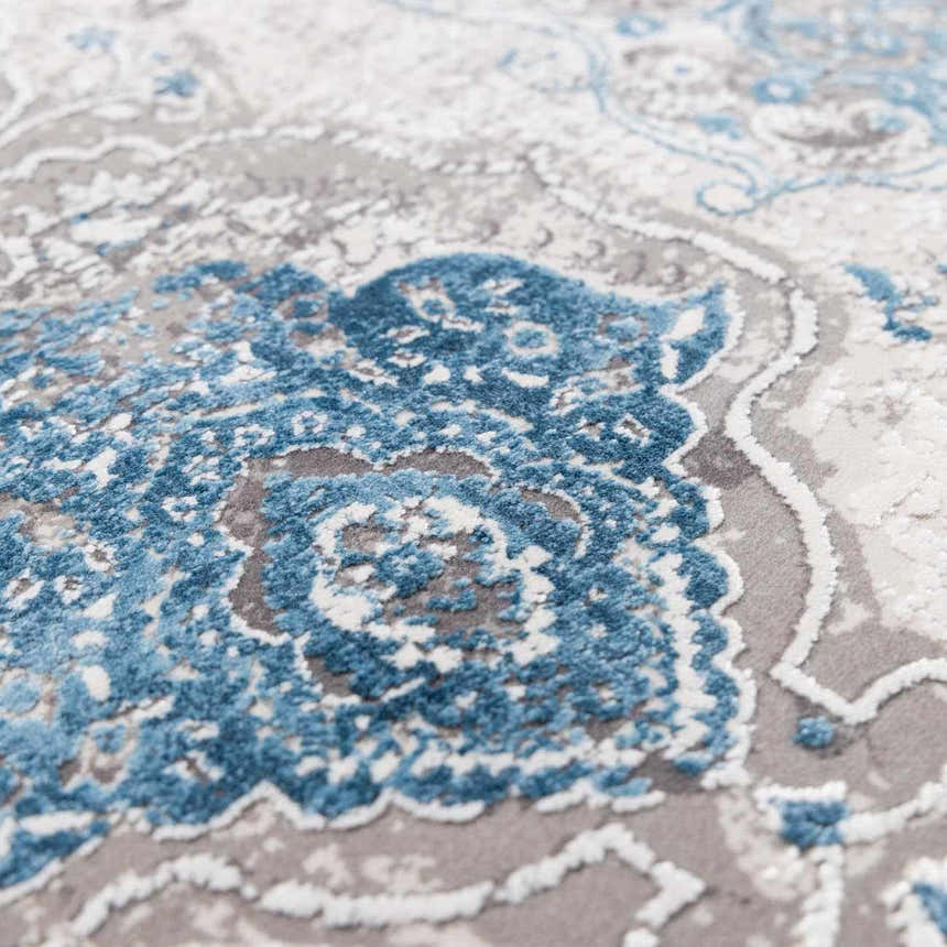 Close-up of the Rydalmere Rug. Ultra soft rug with a traditional pattern in shades of blue, gray and white. Texture