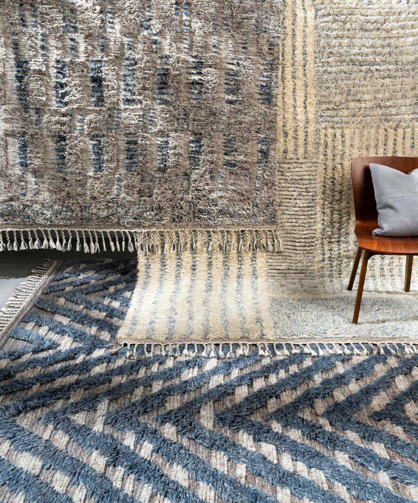 Close-up of Lambsburg Knotted Wool Rug. Features blue, beige, and charcoal colors, plus a textured, geometric design. Styleshot