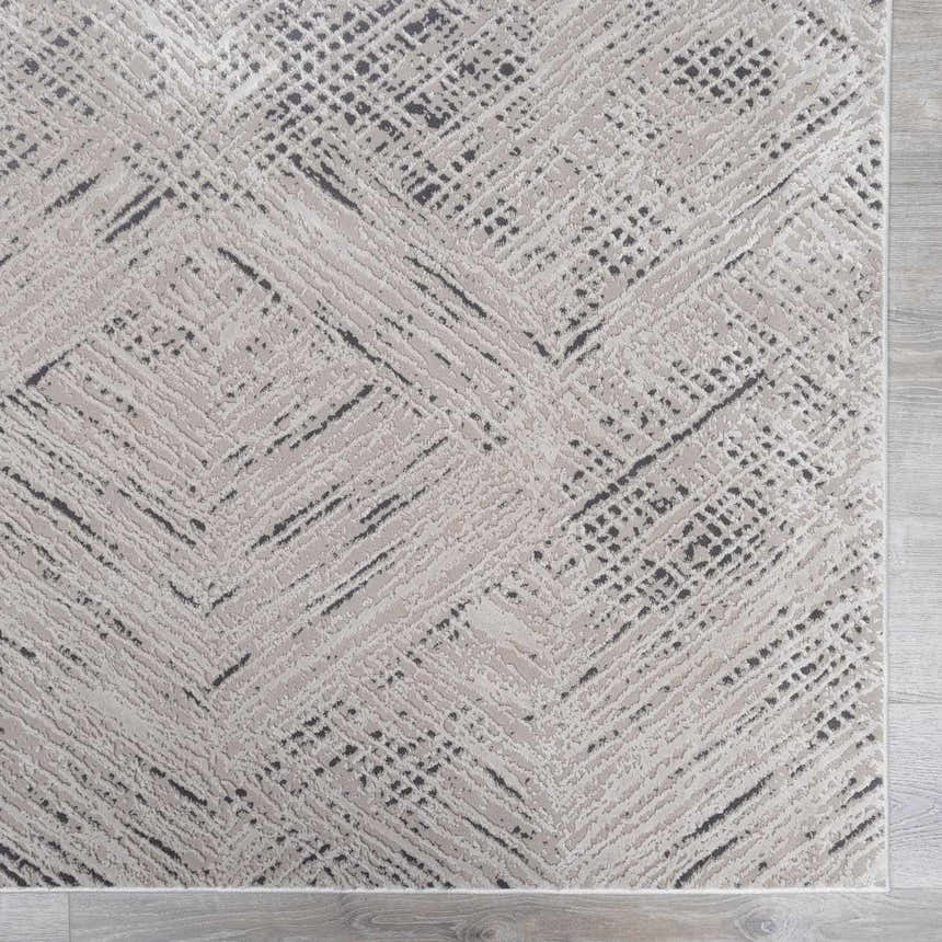 Close-up of the Garza Diamond Textured Washable Rug. Beige rug with a contemporary diamond and line pattern. Swatch