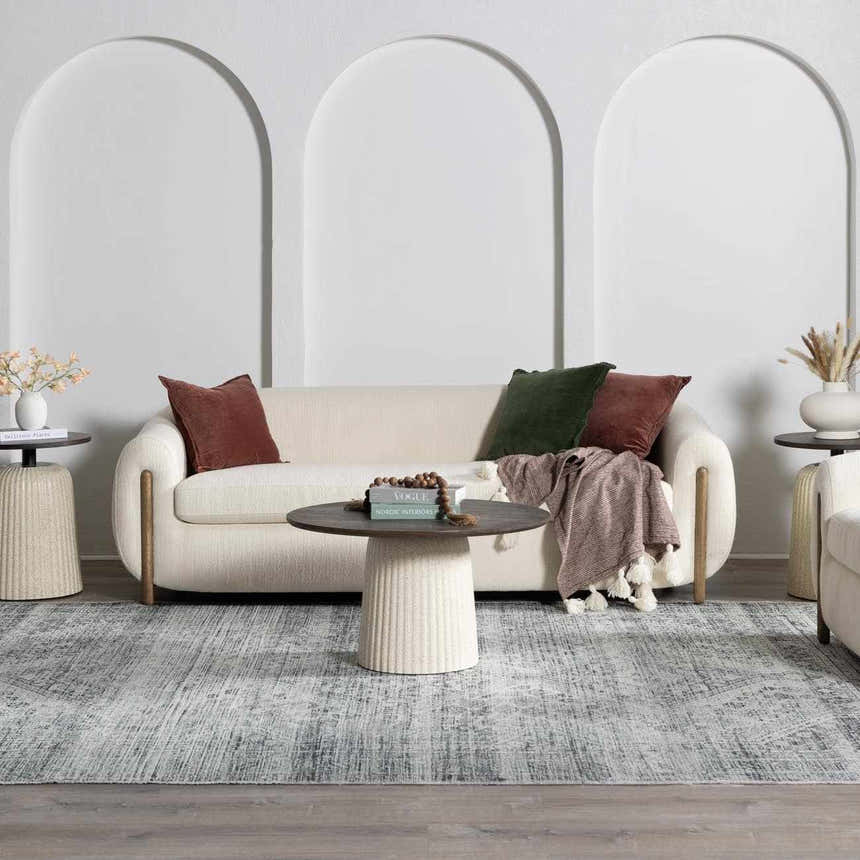 Living room scene with a Barny Gray Blue Washable Rug, cream sofa, round tables, and arched wall decor. Modern farmhouse style. Roomscene-Rectangle