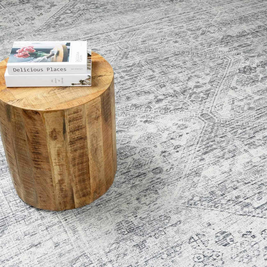 Close-up of the Barny Gray Blue Washable Rug showing its traditional design and gray and off-white color palette. Styleshot