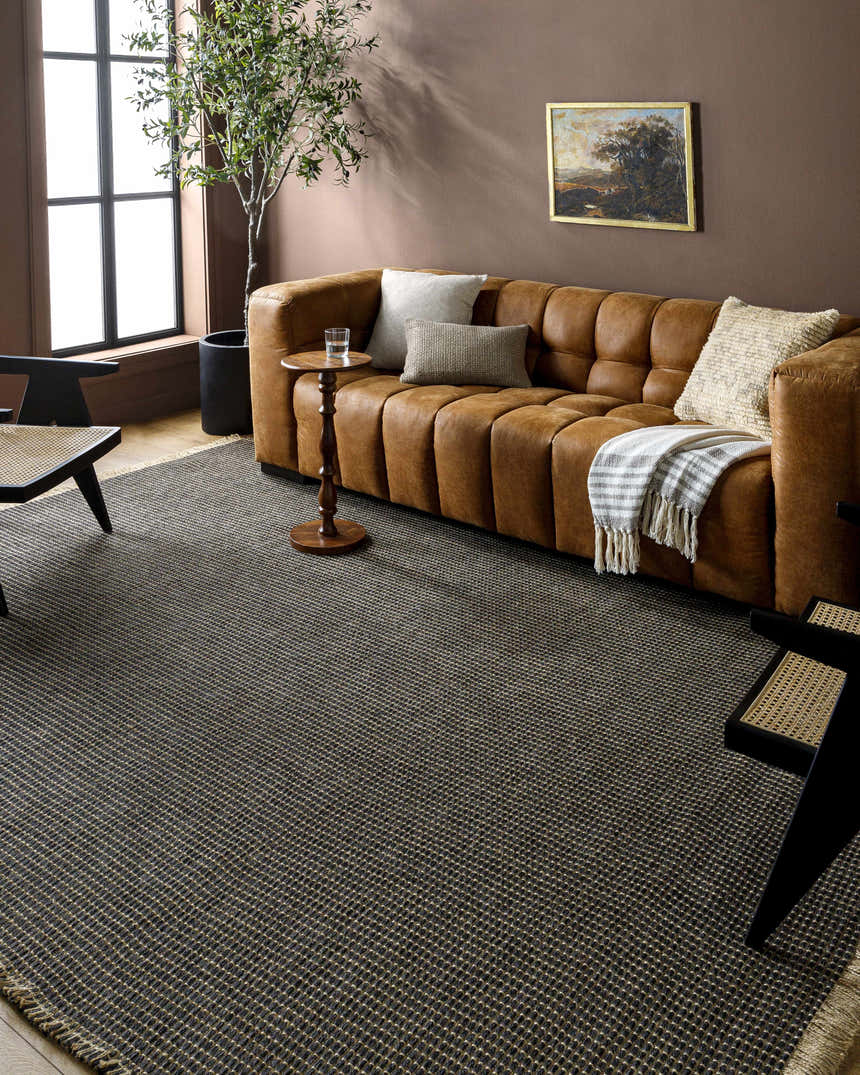 Living room scene with brown leather sofa and Kimi Machine Woven Becki Owens x LIVABLISS rug in black and light brown. Roomscene-Rectangle