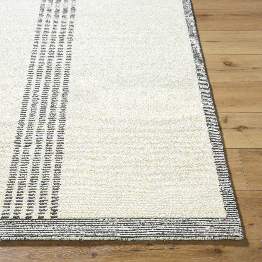 Close up of the hand-tufted Ande Ivory Area Rug showing its silver gray stripes and off-white wool texture. Front