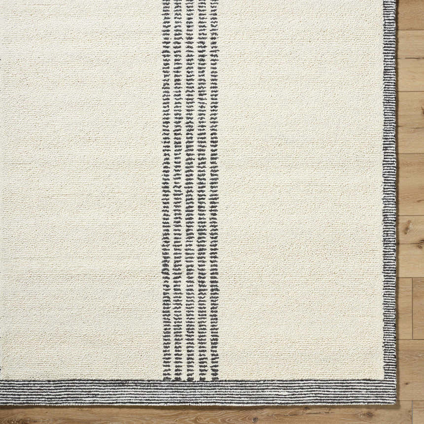 Close up of the hand tufted Ande Ivory Area Rug showing its wool texture and light silver stripes. Swatch