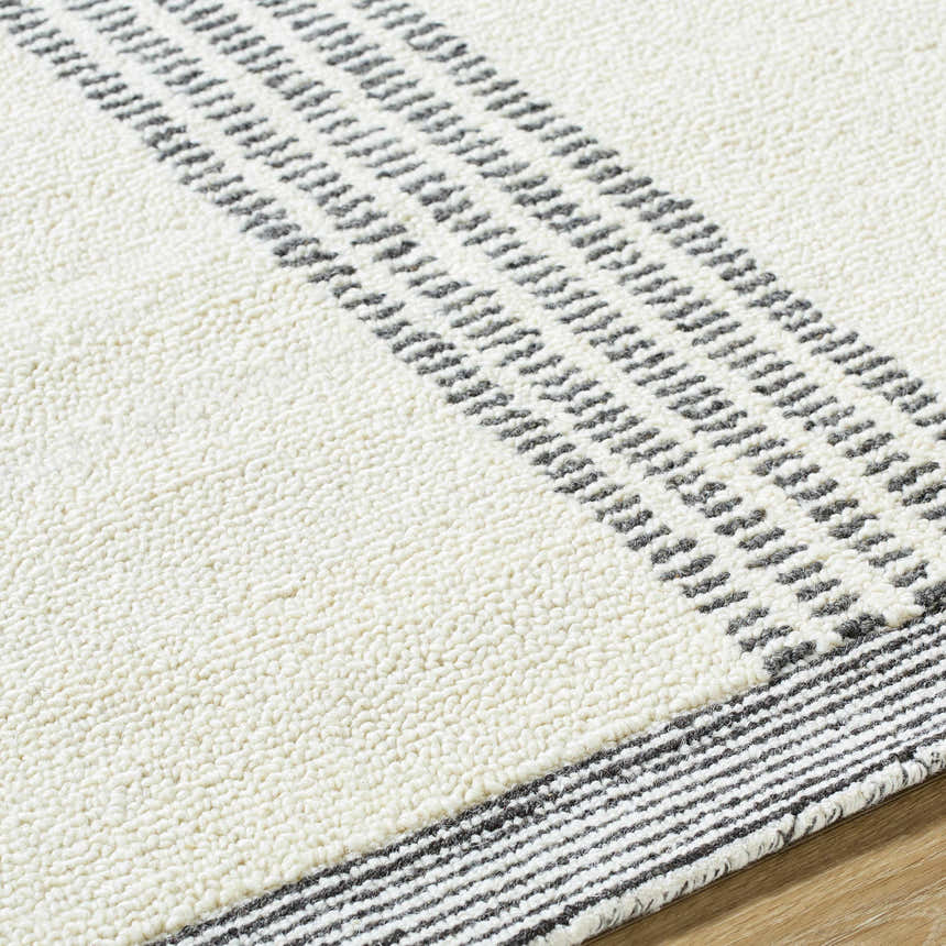 Close-up of the Ande Ivory Area Rug, showing its textured wool and light silver geometric stripe design. Texture