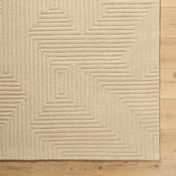 Close-up of the hand-tufted Citro Beige Area Rug showing geometric pattern and textured wool on a wood floor. Corner