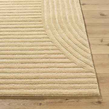 Close-up of the beige Whan Area Rug showing its textured, linear pattern and hand-tufted wool construction. Front