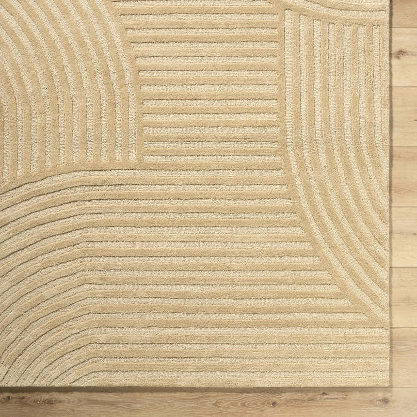 Close up of the hand-tufted Whan Beige Area Rug, showcasing its contemporary linear and curved design. Corner
