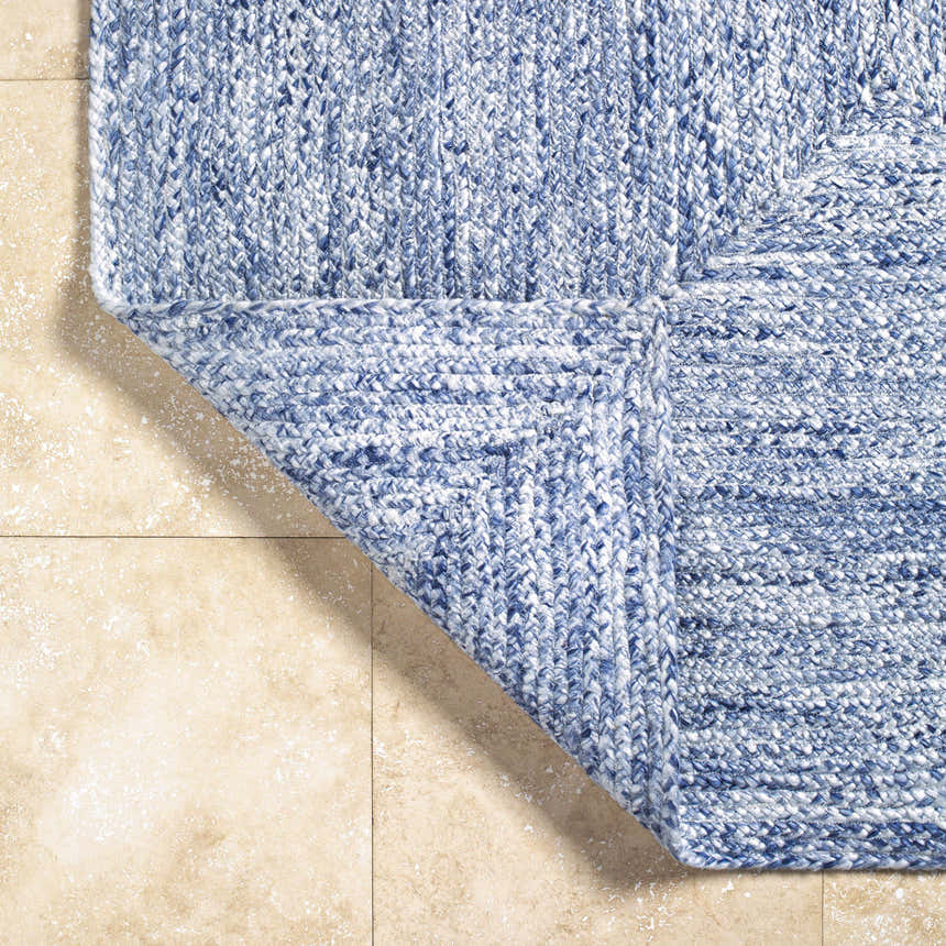 Close up of the hand woven Kenyi Navy Area Rug showing texture and detail. Fold