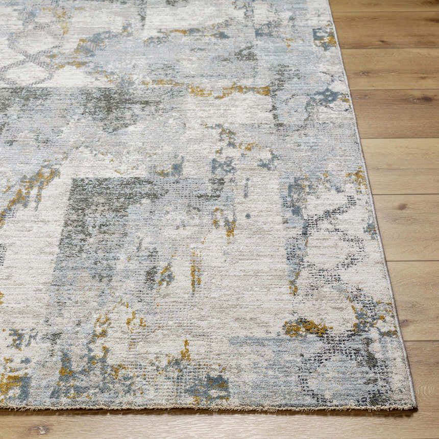 Close-up of the Adlai Textured Rug. The rug features a contemporary design with dusty sage, ink blue, and mustard accents. Front