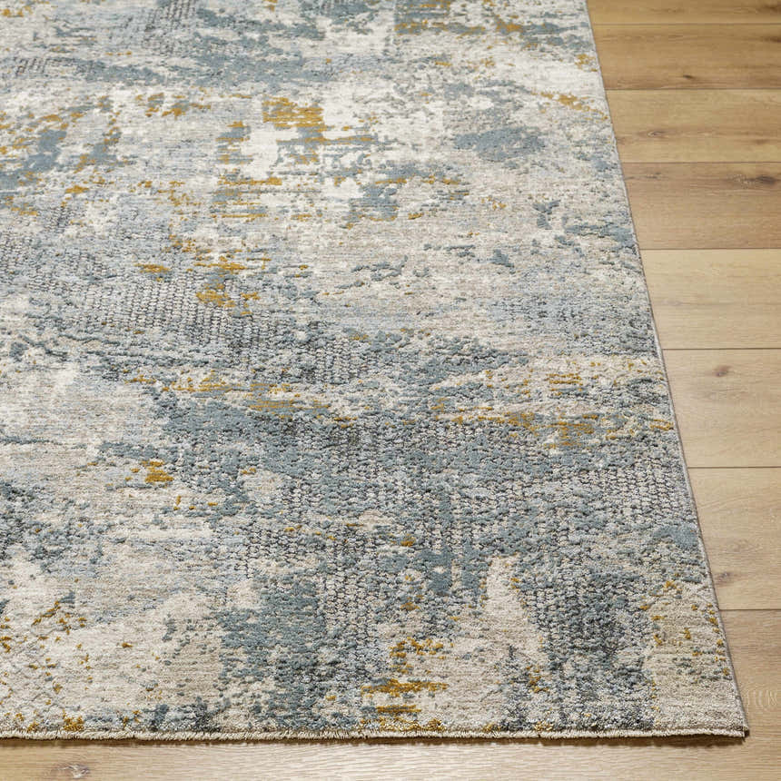 Close-up of the Chaya Textured Abstract Rug. Features dusty sage, ink blue, mustard, and gray tones. Modern design. Front