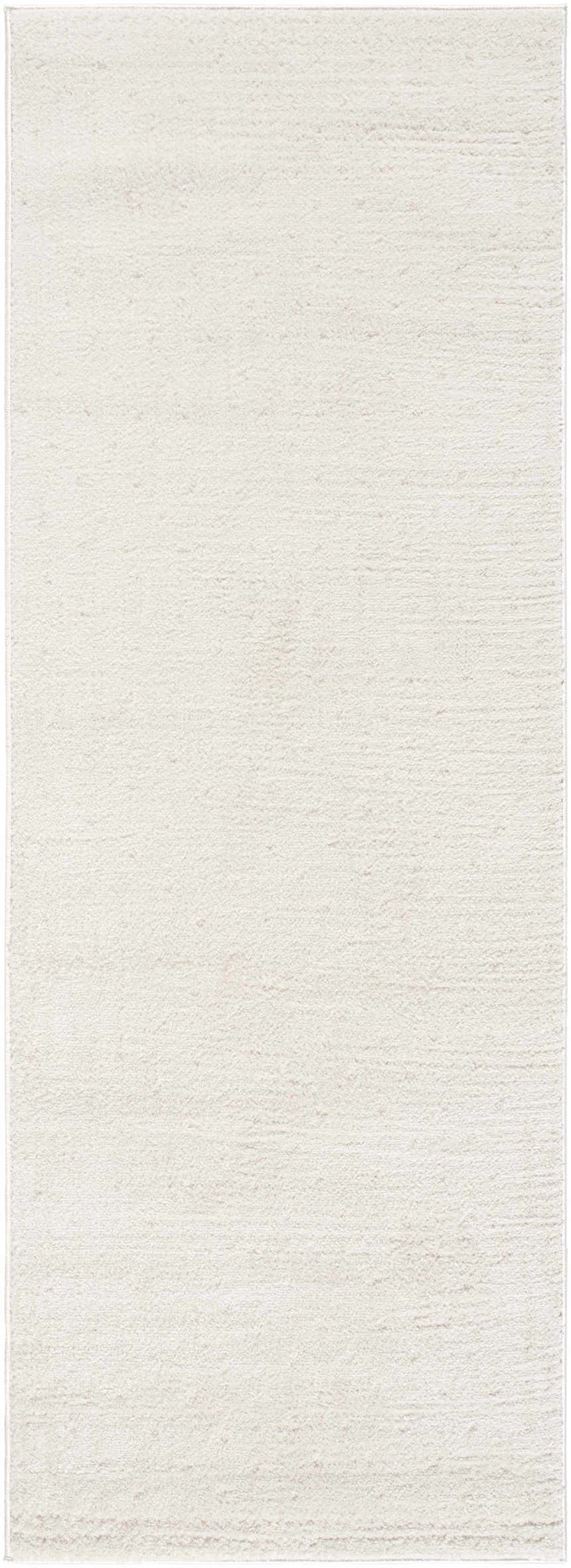 Close-up of the Julie Ivory Area Rug. Soft, textured beige and ivory rug with a subtle horizontal pattern. Design-Runner-2773