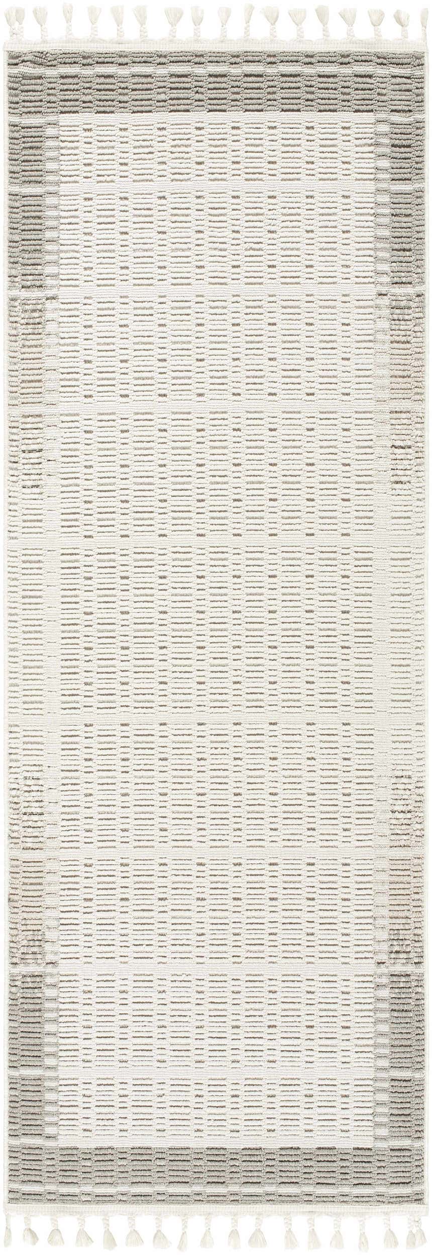 Close-up of the Ajda Area Rug, a machine-woven rug with a geometric pattern in beige, bone, and gray tones with tassels. Design-Runner-2773