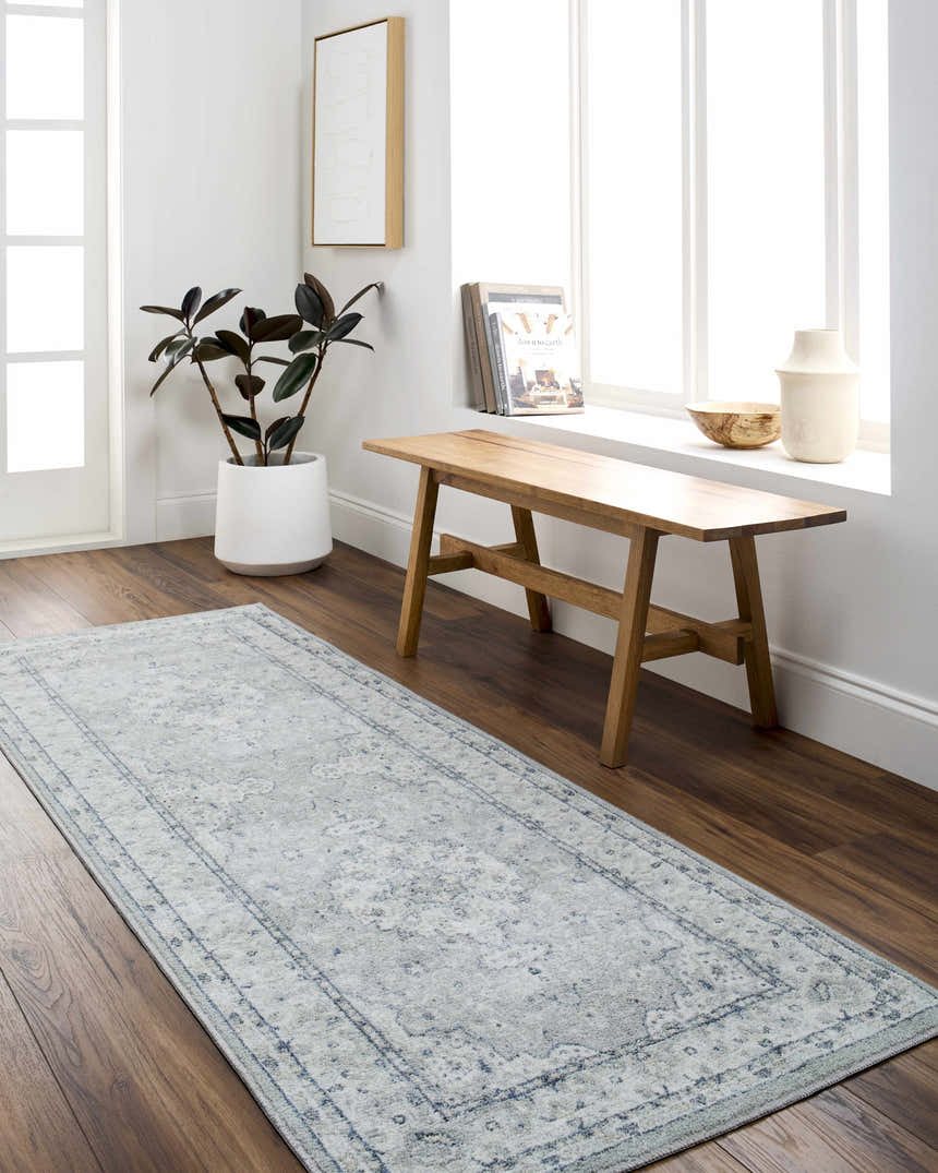 Entryway with wood floors and Farai Gray Medallion Area Rug, bench by window, plant, and modern decor. Roomscene-Runner