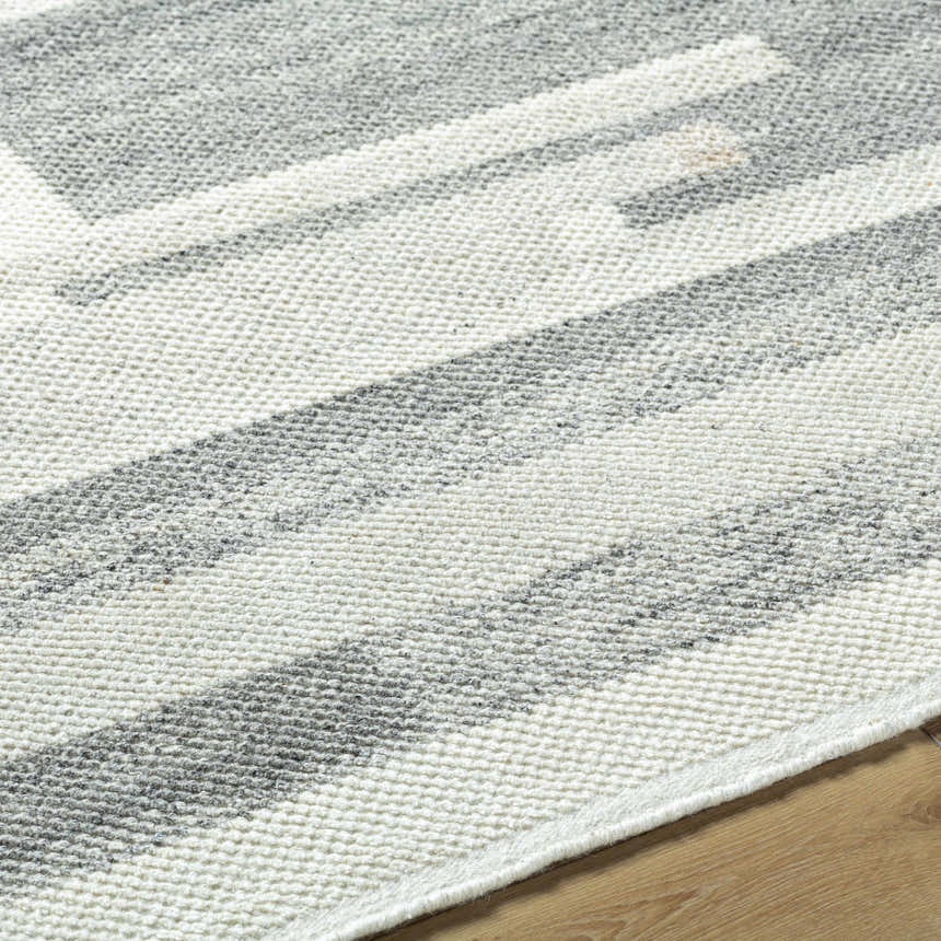 Close up of the hand knotted Fadri Area Rug. Beige and ivory geometric pattern in 100% wool. Texture