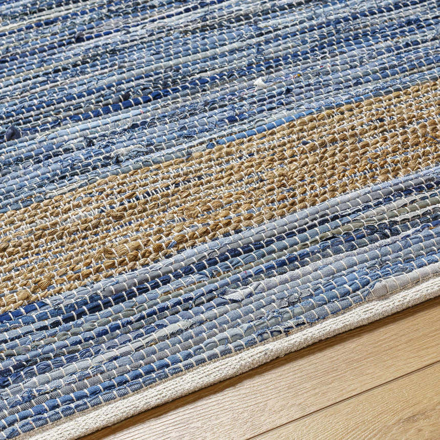 Close-up of the Ghita Recycled Blue Jean Rug, showcasing its hand-woven texture and stripes of blue denim and beige jute. Texture