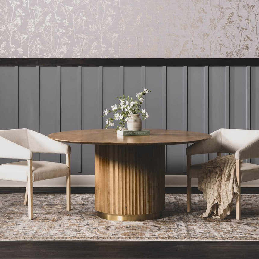 Dining room scene with a round wood table on a charcoal and beige Dion Washable Floral Rug. Roomscene-Rectangle