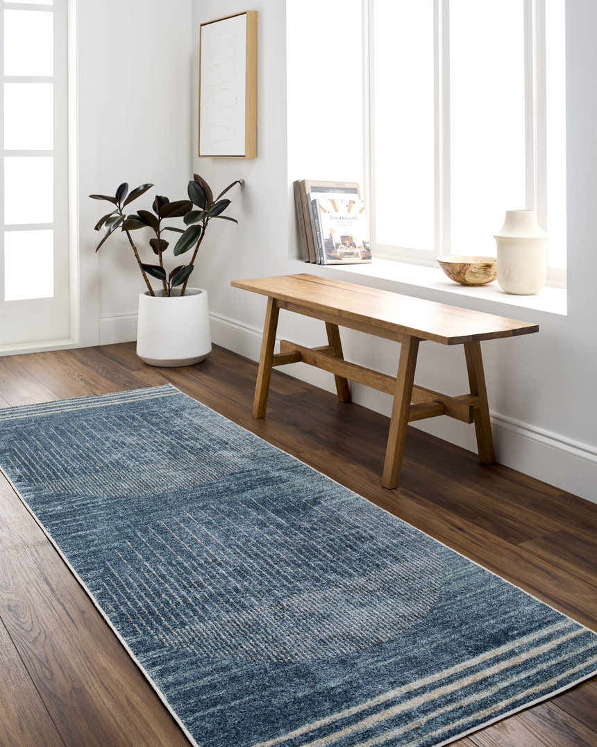 Bright hallway with Thad Blue Washable Area Rug, wood bench, plant, and decor. Contemporary style. Roomscene-Runner