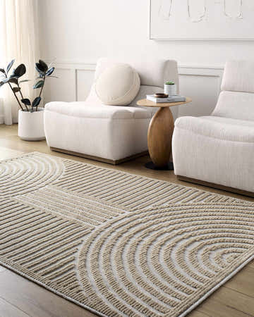 Living room scene with beige Deron Washable Area Rug, white chairs, wood side table, and modern decor. Roomscene-Rectangle