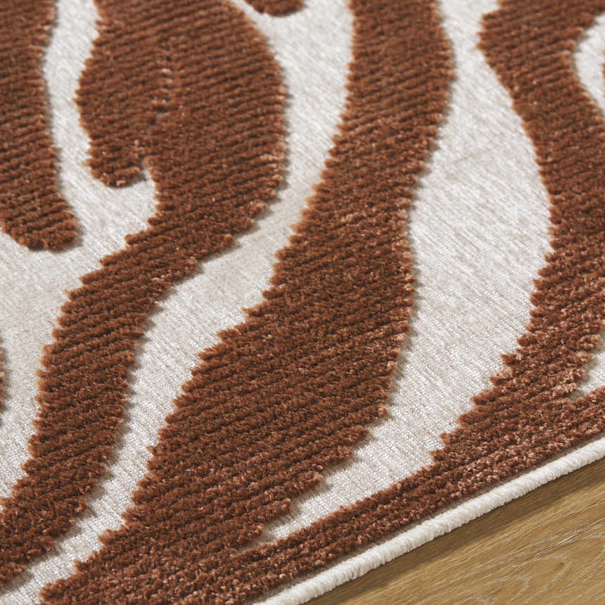 Close-up of the Keto Brown Washable Area Rug showing the brown and off-white contemporary pattern and soft texture. Texture