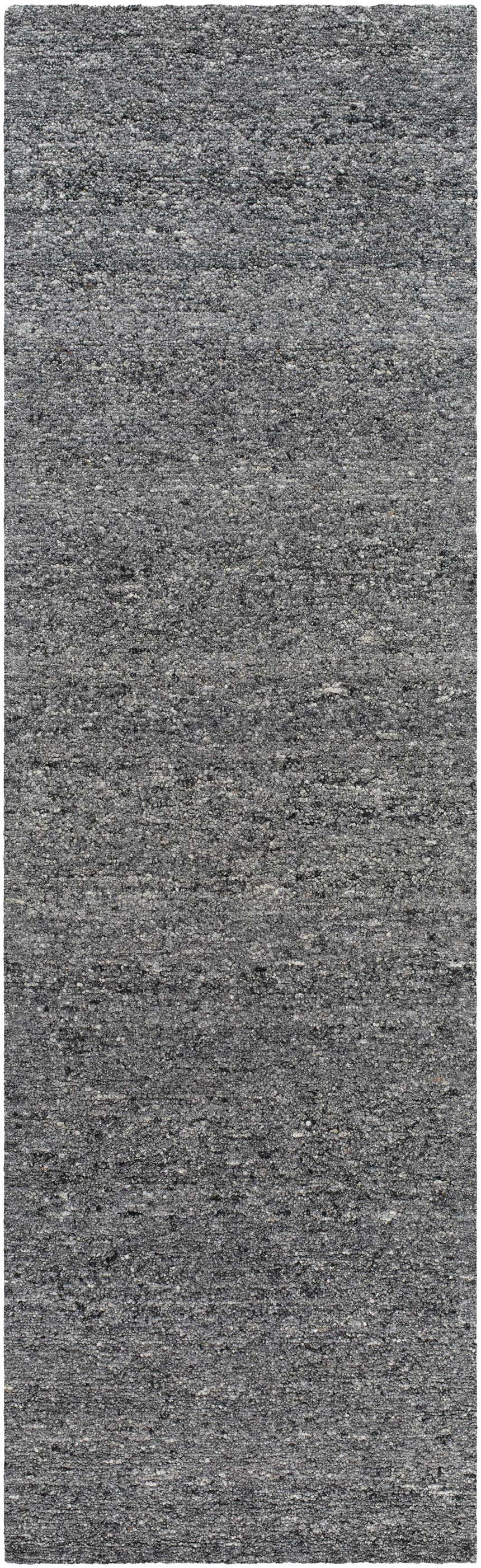 Close-up of the Sevan Charcoal Wool Area Rug, showing the gray, black, and steel gray tones and hand-tufted texture. Design-Runner-310