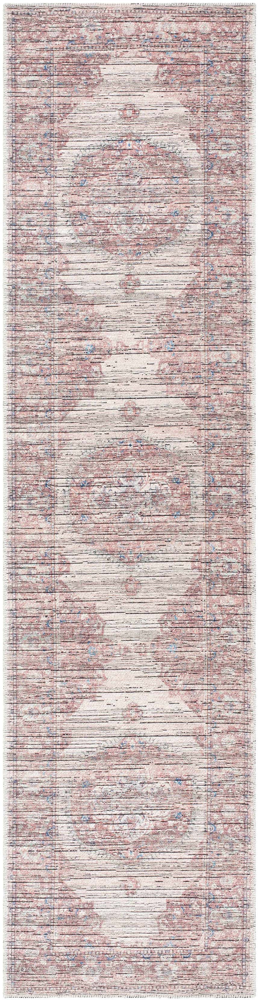 Close-up of the Maja Area Rug. Farmhouse style rug in beachhouse, red, and blue tones with a traditional pattern. Design-Runner