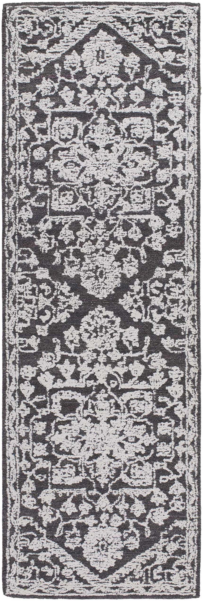 Close-up of the Black Derya Area Rug. Hand-tufted runner rug in charcoal and light gray with a traditional floral pattern. Design-Runner-268