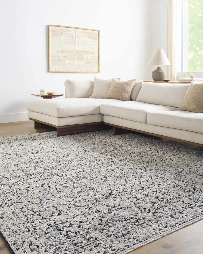 Living room with a neutral sectional sofa and the Haran Cloud Gray Area Rug with a subtle traditional pattern. Roomscene-Rectangle
