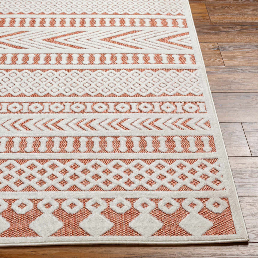 Close up of Jove Orange Outdoor Rug showing Southwestern geometric pattern in bone and terracotta. Front