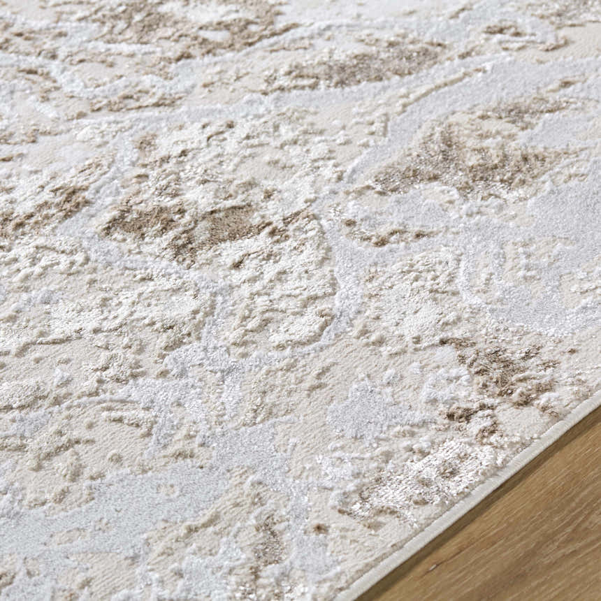 Close up of the beige and cream Kaleo Area Rug showing its contemporary pattern and soft texture. Texture