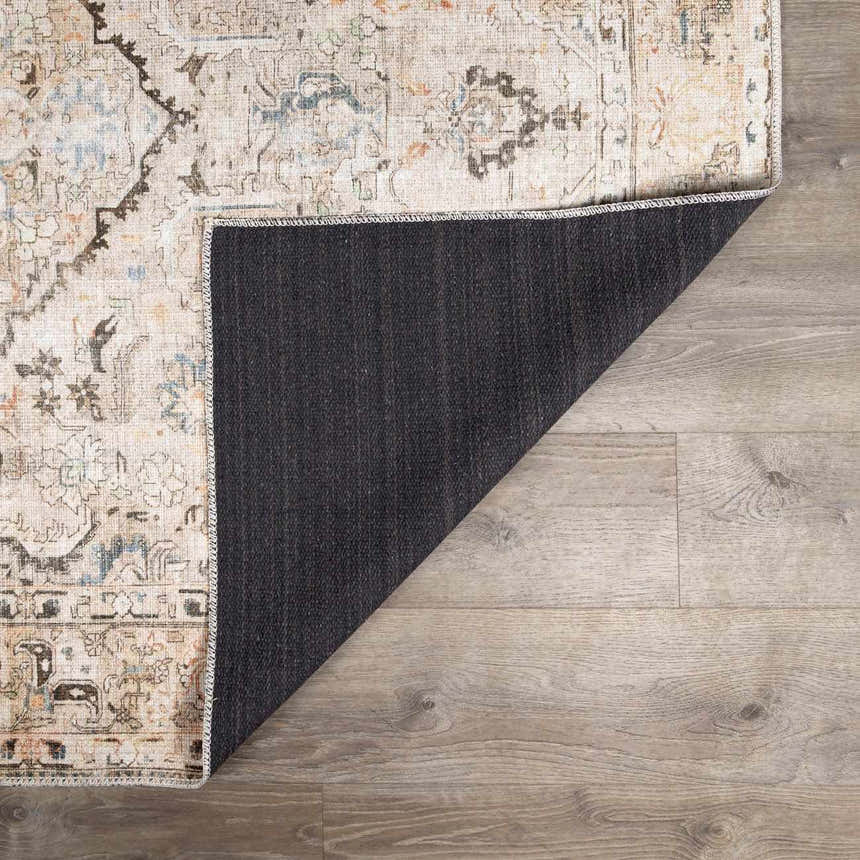 Close up of Standon Vintage Washable Rug showing the Persian-style pattern, colors, and non-slip backing. Fold