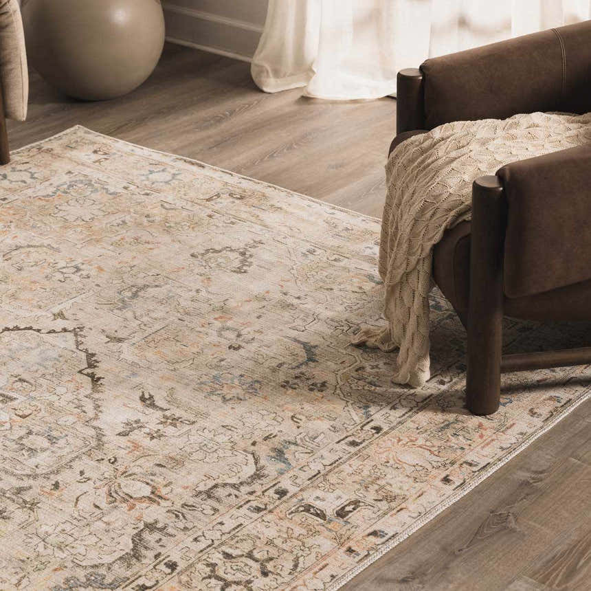 Living room scene with a Standon Vintage Flat Pile Washable Rug, brown leather chair, and neutral tones. Styleshot