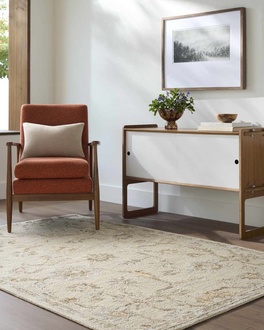 Living room scene with a beige Adelle Tufted Oushak Area Rug, orange chair, and mid-century modern cabinet. Roomscene-Rectangle