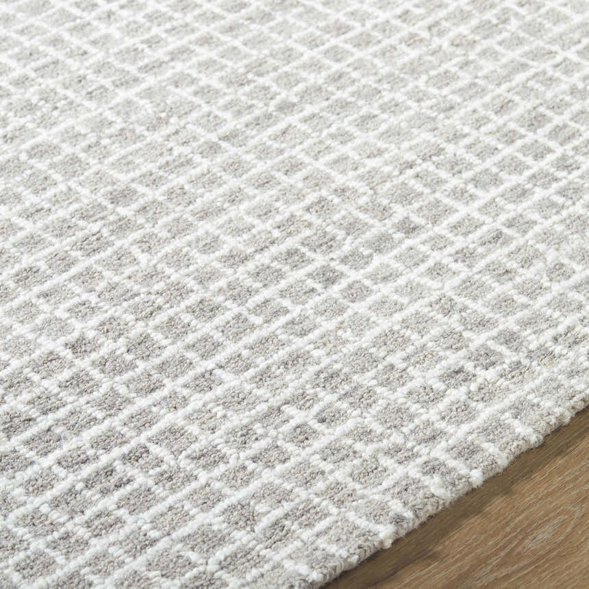 Close-up of the hand-tufted Anahid Gray Area Rug. Checkered pattern in ash, light silver, and off-white wool. Texture