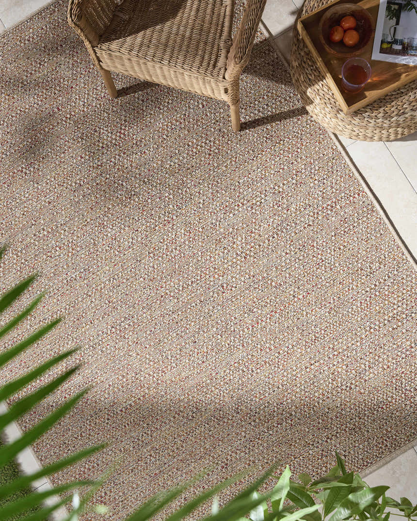Close-up of the Thanh Beige Area Rug showing its woven texture and beige, coral, and mustard color variations. Roomscene-Rectangle