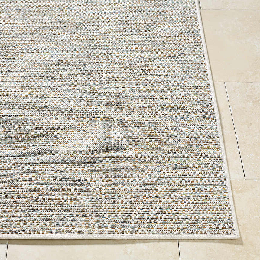 Close-up of the woven texture and neutral colors of the Thanh Ivory Area Rug on a beige tile floor. Front