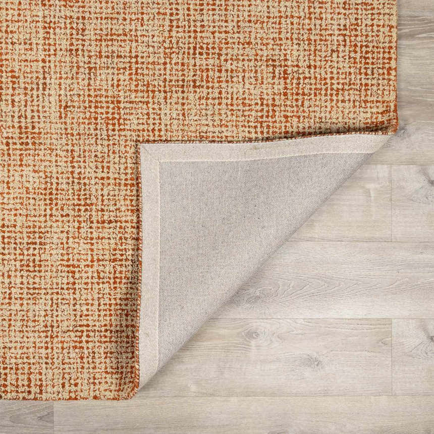 Close up of the Teresita Area Rug, a burnt orange and ivory hand tufted wool rug with a contemporary grid pattern. Fold