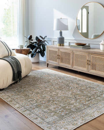 Living room scene with a tan sofa and the Tisha Washable Area Rug in gray, silver, and tan tones. Roomscene-Rectangle