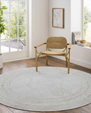 Light-filled room with a round Taban Luxe Rug in ash and silver gray under a modern chair. Farmhouse style. Roomscene-Round