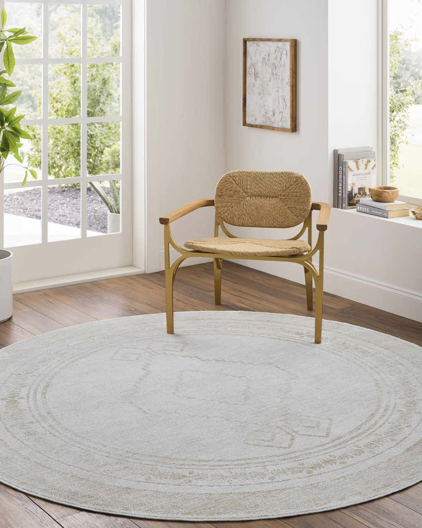 Light-filled room with a round Taban Luxe Rug in ash and silver gray under a modern chair. Farmhouse style. Roomscene-Round