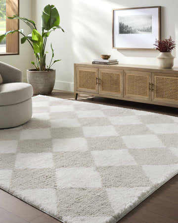 Living room scene with a beige swivel chair and Achaia Beige Area Rug featuring a checkerboard pattern. Roomscene-Rectangle