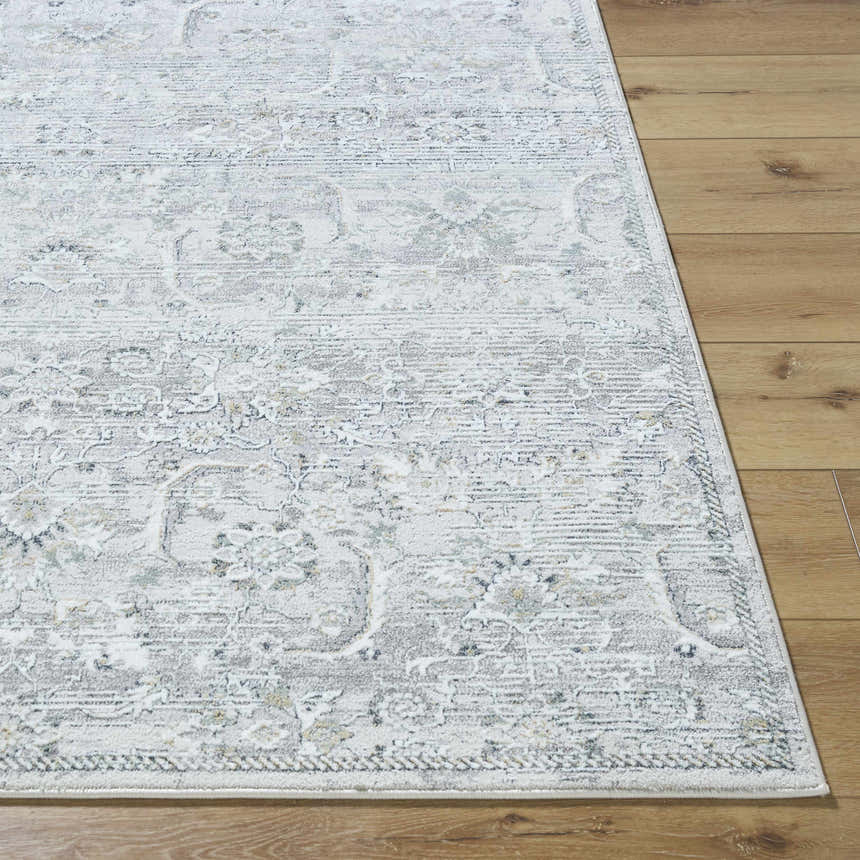 Close-up of Tariq Area Rug. Traditional silver gray and slate blue floral pattern on a farmhouse style rug. Front